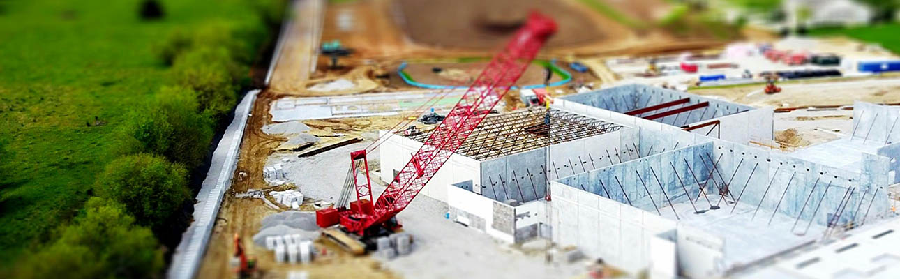 View of a construction crane building a warehouse